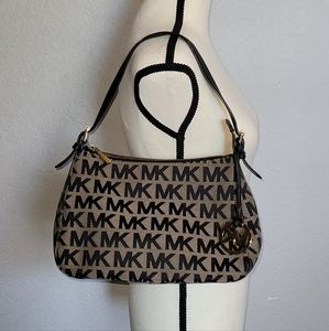 Like new Michael Kors hand bag. Signature black and tan.